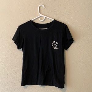 A soft black T-shirt with a dinosaur cartoon.